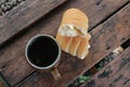 One slice of cheese-flavored bread is cut in two with a cup of hot black coffee typical Indonesian lombok