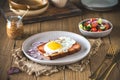One slice of Leberkaese with fried egg on a wooden table Royalty Free Stock Photo