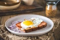One slice of Leberkaese with fried egg on a wooden table Royalty Free Stock Photo