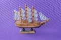 One small brown wooden old model toy ship with white sails Royalty Free Stock Photo