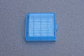 A one small closed square blue plastic box