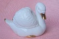 One small figurine of a white ceramic swan Royalty Free Stock Photo