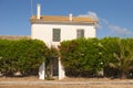 One small house in mediterranean style behind green bushes of oleander Royalty Free Stock Photo