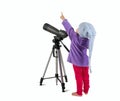 One small little girl looking through spotting scope and pointing up.