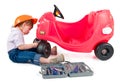 One small little girl repairing toy car.