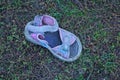 One small old dirty colored summer sandal Royalty Free Stock Photo