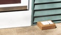 One small package delivered and left on front pourch Royalty Free Stock Photo