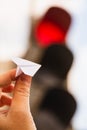 One small paper airplane in hand against a traffic light background. Glowing red prohibition signal. Flight is prohibited. Take-of Royalty Free Stock Photo