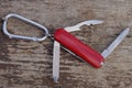 One small red open multitool knife with open gray blades Royalty Free Stock Photo
