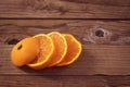 One small ripe tangerine lies against a background of wood Royalty Free Stock Photo