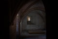 Small window seen from a dark interior of the Tarascon Castle, France Royalty Free Stock Photo