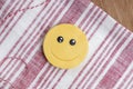 One smiley face iced cookie placed on a wooden tabletop Royalty Free Stock Photo