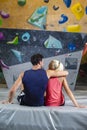 One Smiling Young Joyful couple Preparing To Bouldering climbing up the wall Together While Resting Together Royalty Free Stock Photo