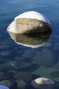 One snow covered boulder in the clean clear waters of Lake Tahoe