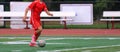 One soccer player dribbling the ball down the field Royalty Free Stock Photo