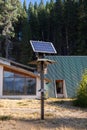 One solar panel in a pole near a modern house in the middle of a forest in Isla Victoria Royalty Free Stock Photo