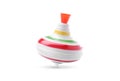 One spinning top in motion on white background. Toy whirligig