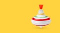 One spinning top in motion on yellow background, banner design with space for text. Toy whirligig