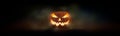 One spooky evil halloween lantern, Jack O Lantern, with glowing eyes and face.