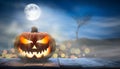 One spooky halloween pumpkin, Jack O Lantern, with an evil face and eyes on a wooden bench, table Royalty Free Stock Photo