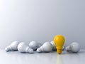 One standing yellow idea bulb with white bulbs on white background Stand out from the crowd business creative idea