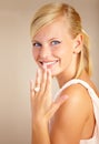 One step closer to happily ever after. Portrait of an excited young woman holding her engagement ring by her face. Royalty Free Stock Photo