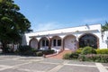 The one-storey building with flowers in front of a bright sunny day