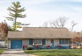 One Story House with Christmas Decor on Blue Picket Fence