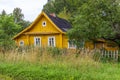 One-story wooden house in the countryside..Old yellow village building, front view