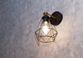 One stylish lamp with warm light hanging on a gray wall. Interior in a hairdressing salon or at home. Lighting room. Royalty Free Stock Photo