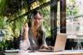 One successful and happy young adult business woman holding a laptop with smile. Professional female worker standing in Royalty Free Stock Photo