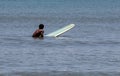 One surfer sitting on his surboardboard waiting for a wave to ride Royalty Free Stock Photo