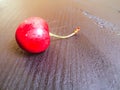 One sweet cherry on the wood table Royalty Free Stock Photo