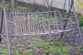 One swing chair made of gray metal and white ropes