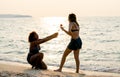 One teen girl give rose to the other teen and they look happy together with warm light of sunset in the background during holiday Royalty Free Stock Photo