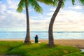 One teenage girl sitting alone on Hawaiian beach watching ocean Royalty Free Stock Photo