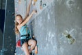 One teenager climbing a rock wall indoor. Royalty Free Stock Photo