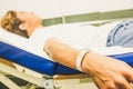 One teenager lying on the bed of the hospital - sick man waiting at the doctor alone