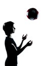 One teenager silhouette tossing soccer football