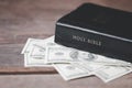 One tenth or tithe is basis on which Bible teaches us to donate one tenth of first fruit to God. Coins with Holy Bible. Religion