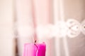 One thick pink candle, fire extinguished, object on a light background