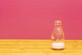 One-third pint milk bottle with dregs of strawberry milkshake Royalty Free Stock Photo