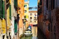 One of a thousand mini-canals among beautiful and decadent Venetian buildings.