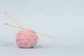 One thread ball and wooden bamboo knitting needles on light blue background. Hobby, relaxation, mental health Royalty Free Stock Photo