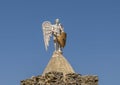 One of three archangel statues atop a stone building, part of the Monastery of Saint Simon.