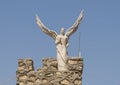 One of three archangel statues atop a stone building, part of the Monastery of Saint Simon.