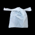 one tied white plastic bag isolated on black