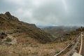 One of the tight turns of a narrow rural road in the mountains of Parque Natural Majona. View of the gorge and San Sebastian, the