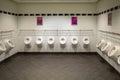 in one toilet there are many urinals next to each other Royalty Free Stock Photo