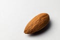 One tonsil on a white background. Almonds close-up, texture visible Royalty Free Stock Photo